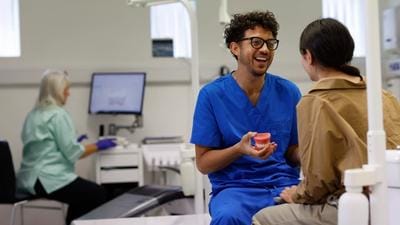 An orthodontic therapist discusses retainers with a patient